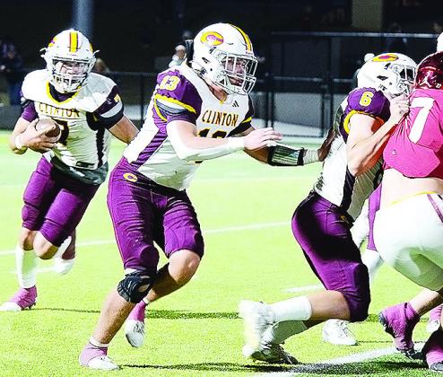 No. 7 Easten Powell carries the ball as he follows the blocking of No. 13 Vince Jones and No. 6 Benton Bridgeman during Clinton’s first-round loss to the Tigers in Tuttle. CDN | Micah Ashcraft