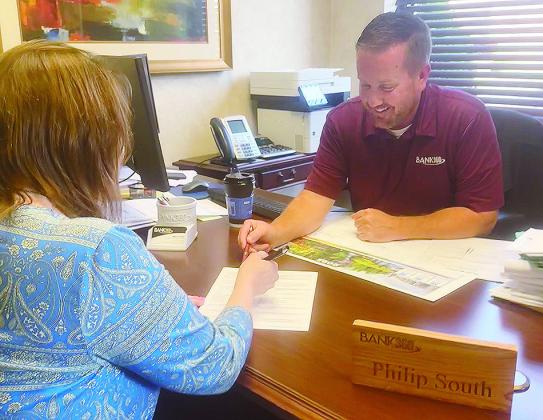 Phillip South uses his expertise as a mortgage loan officer with Bank360 to help a customer. CDN | Shiann Dawson