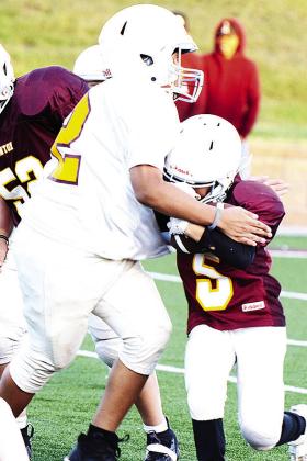 No. 72 Chase Spottedwolf tries to take down Adrien Lopez as he carries the ball during their Clinton Next game. CDN |Sam Goodwyn
