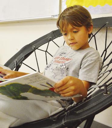 Andrew Countryman works on his reading skills with a book.