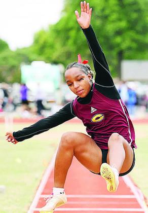 Clinton’s Peyton Clonce twists in the air as she performs in the long jump during the track meet at Weatherford. CDN | Steve Wheeler