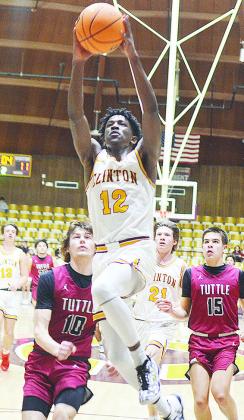 Clinton’s Atticus Thompson takes flight toward the basket during the Reds’ home win over the Tuttle Tigers Friday night in the Tornado Dome. CDN | Sam Goodwyn