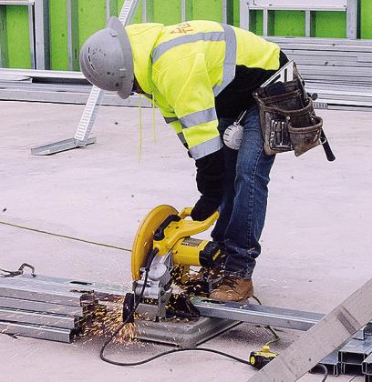 Uriber Salas cuts some metal Tuesday as he helps build the new Oklahoma Highway Patrol facility on Gary Boulvard. CDN | Sam Goodwyn
