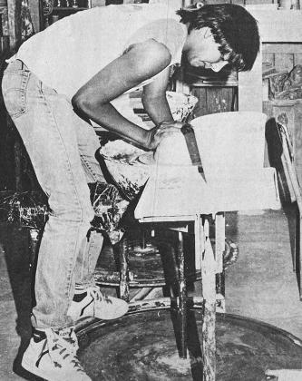 40 YEARS AGO John Bearshield, an Arapaho High School freshman, used a kick wheel to make a pottery container. He is standing on a rim above the moving kick wheel in order to put his weight against the moving clay as he worked to center and raise the pot.