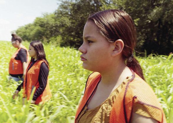 From left, Meraelie Sevenstar, Rainie Forrest, and Brynlee Nowlin look for a missing person for the short film “The Red Echoes” shot in August of 2025 at E. 1070 Road in Clinton. CDN | Courtesy photo