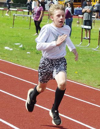Zayden Almquist hustles down the track during the Little Olympics Day at the high school to end the school year. CDN |Sam Goodwyn