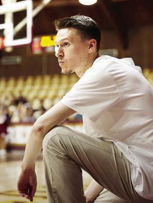 Clinton High School boys’ basketball coach Mark Seiter kneels on the sideline during a game as he focuses on his team in the Tornado Dome. CDN | Courtesy photo