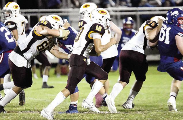 Clinton’s No. 10 JJ Ruiz carries the ball against Chandler Friday while No. 66 Andre Lime and No. 75 Eli Anderson provide blocks for him during the road game. CDN | John Kinsey