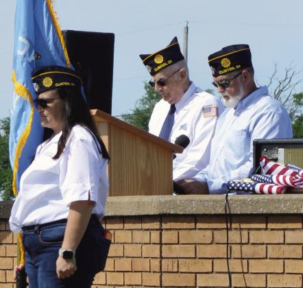 Monday at the Clinton Cemetery VFW Vice Commander Heidi Teeter, left, holds the Oklahoma flag as past Post Commander Don Miller, and Post Commander Keith Brisco read the names of the veterans that have recently died. CDN | Christian Jacobsen