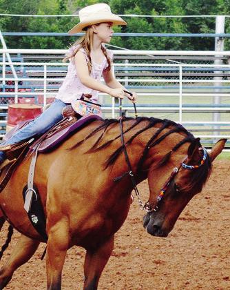 Peewee Princess Vivien Salinas trots for the judges with her horse Autumn Thursday evening as part of the Clinton Round-Up Club’s Rodeo Royalty contest held at the Clinton Rodeo Grounds. CDN | Micah Ashcraft