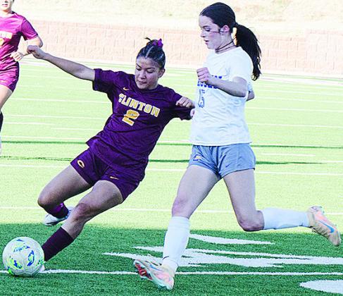 Clinton’s Sammy Meraz, left, beats the Classen defender to the ball during the Lady Reds’ win Thursday over the Lady Comets. CDN | Sam Goodwyn