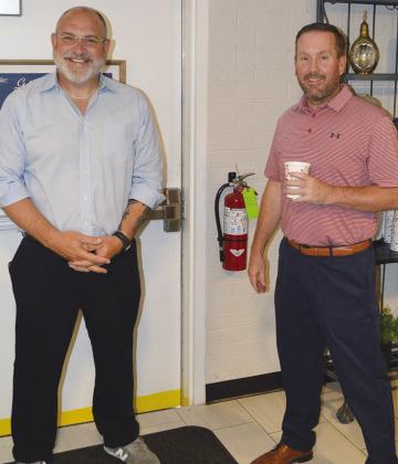 Brandon Lee, left, and Philip South introduce themselves to guests at the Chamber of Commerce Morning Mixer at Lee Hometown Funeral Home. CDN | Christian Jacobsen