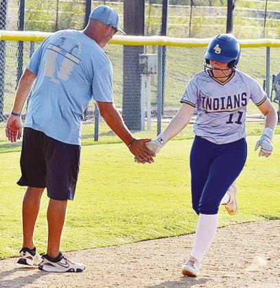 A-B’s Peyton Lambeth, right, shakes hands with Coach Luke Thompson as she rounded third base during her homerun trip around the bases in the Lady Indians’ win over Cheyenne-Reydon Friday at home. CDN | Sam Goodwyn