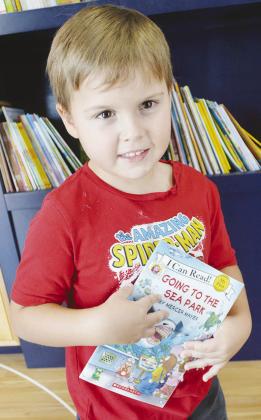 Judah Wagnon decides to select “Going to the Sea Park” as his free book from the Rolling Thunder Book Bus at the Frisco Center. CDN | Christian Jacobsen