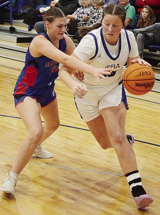 No. 35 Kate Stewart, right, fights to get by her defender during Corn Bible’s win over the Lady Trojans of Sharon-Mutual. CDN | Sam Goodwyn