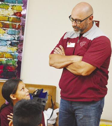 Paris Nava, left, and Clinton Public Schools Supt. Nathan Meget talk about being hardworking, during the “Character Champions” lunch at Washington Elementary School. CDN | Micah Ashcraft