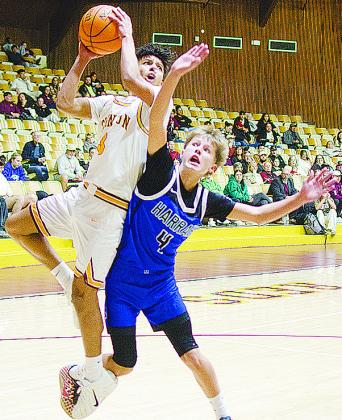 Clinton’s Titan Malone shoots the ball as he goes through a Harrah defender during the Reds’ overtime win Tuesday at home over the Panthers to open the season. CDN | Sam Goodwyn