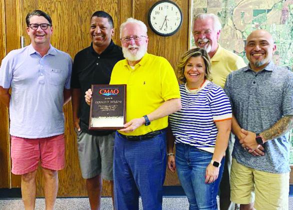 The smiles are so big because the Clinton City Council and city manager were asked to say “executive session” when the photographer took the picture. From left are Ernie Dowdell, Art Lloyd, City Manager of the Year Robert Johnston, Stormie Bowen, Mayo