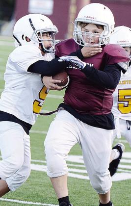 Matthew McAtee, left, tries to tackle Jaxen Patton during their Clinton NEXT League peewee football game. CDN |Sam Goodwyn