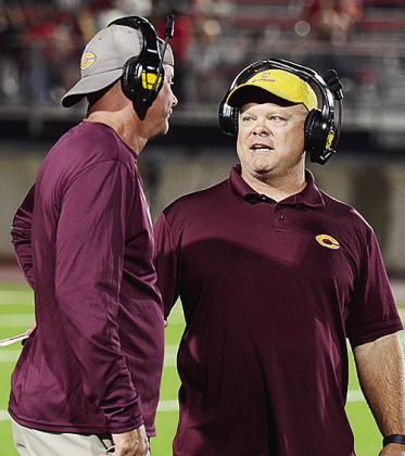 Acting Coach Gene Ray, right, speaks with Special Teams Coordinator Cory Strahorn during Clinton’s road game at Cache. CDN | Micah Ashcraft