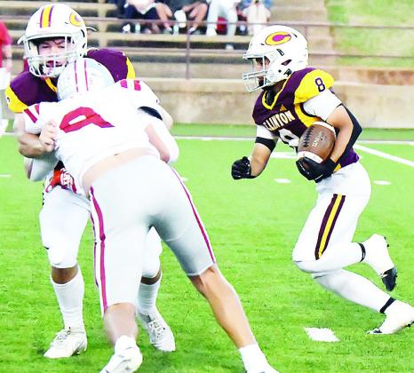 Clinton’s Benton Bridgeman, left, blocks Weatherford’s Kalen Clift, as No. 8 Jaden Potter hustles through with the ball during the Red Tornadoes’ win in the “Custer County Conflict” Friday in the Tornado Bowl. CDN | John Kinsey