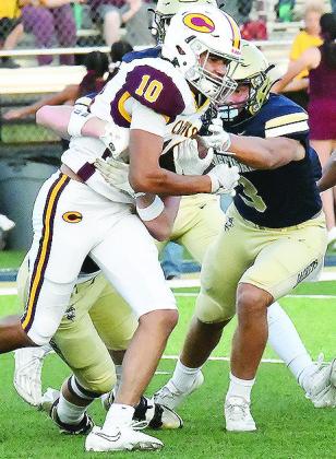No. 10 JJ Ruiz fights through two defenders during Clinton’s road game Friday in Kingfisher. CDN | John Kinsey