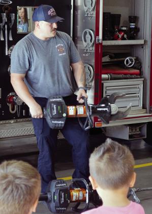 Firefighter Austin Long demonstrates the “Spreader” and “Cutter” to Western Oklahoma Christian School pre-k and kindergarten students at the Clinton Fire Department. CDN | Christian Jacobsen