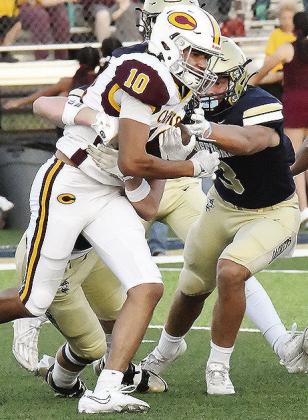 No. 10 JJ Ruiz fights through two defenders during Clinton’s road game Friday in Kingfisher. CDN | John Kinsey