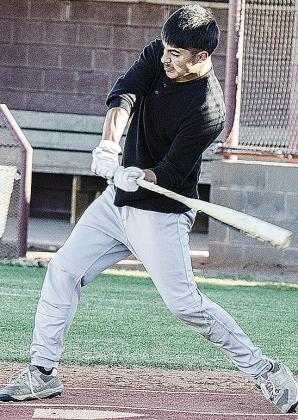 Jesus Gutierrez puts all of his might behind the swing during baseball practice. CDN | Sam Goodwyn