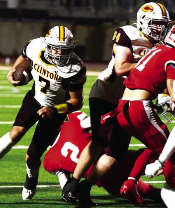 Clinton’s No. 7 Easten Powell cradles the ball as he runs around a block provided by No. 64 Connor Richardson during the Red Tornadoes’ road game in Cache. CDN | Micah Ashcraft