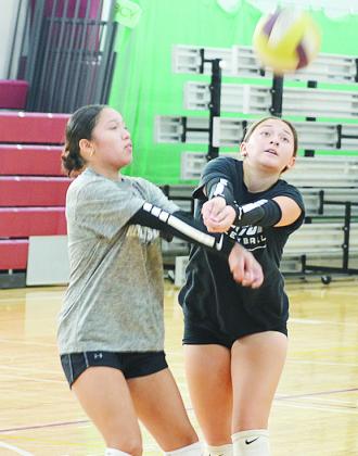 Ayleen Cervantes, left, and Aliyah Lopez team up to send the ball back over the net during volleyball practice. CDN | Sam Goodwyn