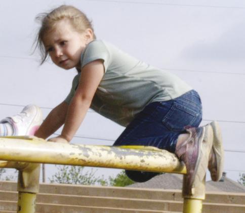 Eden Wright climbs to the top of the monkey bars at Nance Elementary. CDN | Christian Jacobsen