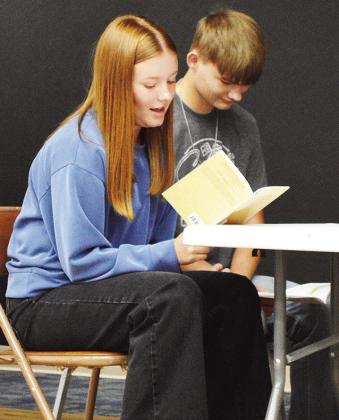 Bentli Whitson, left, and Will Kindsfather read through a scene together during a rehearsal for the Corn Bible Academy senior play. CDN | Micah Ashcraft