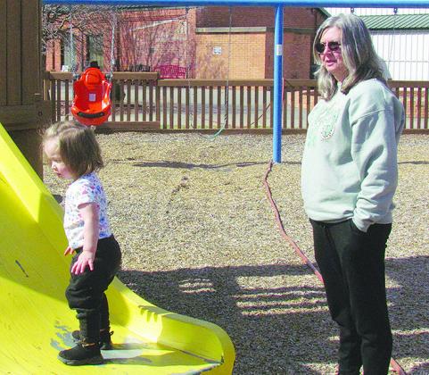 Brynlee Zapien, left, plays with her Grandma Deidre Scott on the slide at the M.T. and Helen Gholston Children’s Park.