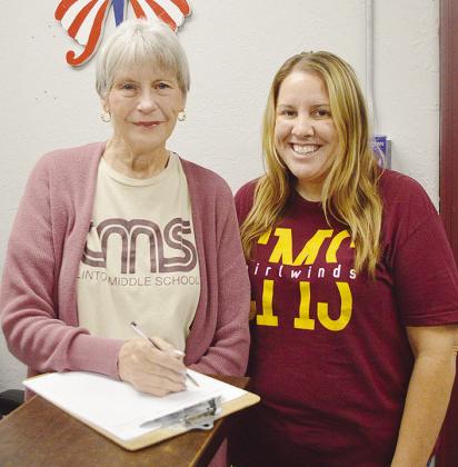 Connie Cabaniss, left, and Shelbie Starnes fill out some paperwork in the front office of Clinton Middle School.