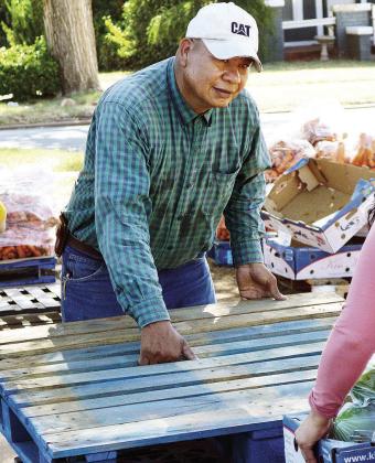 Javier Ochoa helps move empty pallets from the food truck Tuesday at the Mission House. There were 22 pallets of food delivered. CDN | Christian Jacobsen