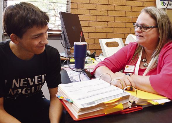 Brycen Farmer, left, and Clinton High School Counselor Casey Perez go over goals for the year in her office Thursday afternoon. CDN | Micah Ashcraft