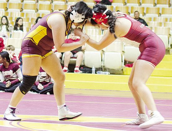 Clinton’s Kassandra Kaline, left, grapples with her opponent from Hinton during the Lady Reds’ home exhibition match with the Lady Comets. CDN | Sam Goodwyn