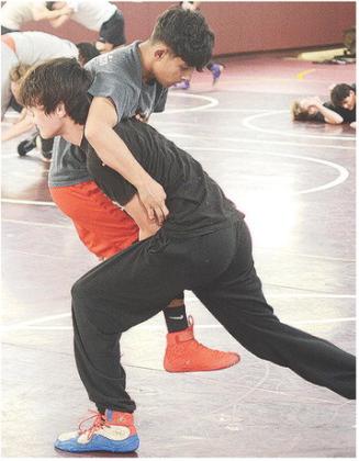 Clinton’s Lucas Jantz, right, lifts Mathew Bermea into the air during wrestling practice Monday. CDN |Sam Goodwyn