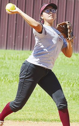 Senior Audrina Trout hurls the ball toward first during practice Tuesday at the softball fields. CDN | Sam Goodwyn