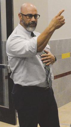 Clinton Public Schools Supt. Nathan Meget points out the hallway leading to the planned library while giving members of the Philanthropic Educational Organization’s local chapters a tour of the newly constructed Clinton Middle School Building. CDN | Mic