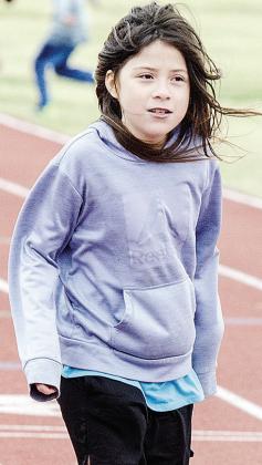 Zofia Melchor embraces the wind as she waits the start of the race during Little Olympics. CDN |Sam Goodwyn