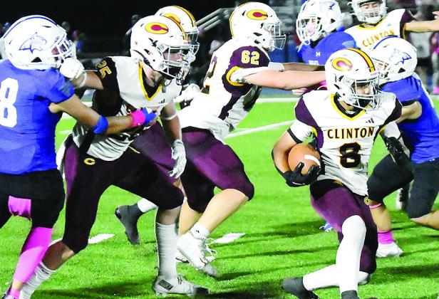 Clinton’s No. 8 Jaden Potter carries the ball as No. 25 Gavin Evans and No. 62 Layne Spitz provide blocks for him during the Red Tornadoes’ road game Friday against Bridge Creek. CDN | John Kinsey