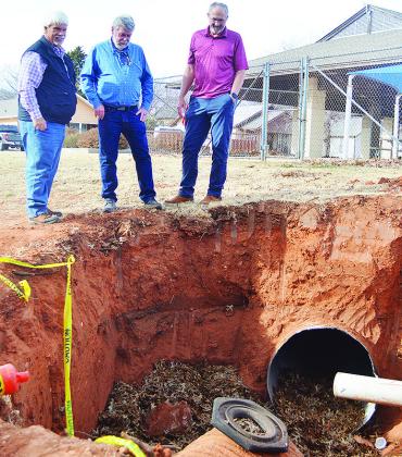 From left, Dist. 1 Commissioner Wade Anders, Gary Brickley, and Clinton Public Works Director Gene McCullough take note of the state of a damaged drainage pipe Monday afternoon in McLain Rogers Park, just outside of the Clinton Public Pool. CDN | Micah As