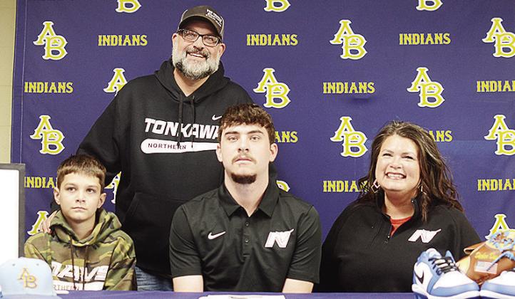 Arapaho-Butler’s Decker Davis, center, sits with his brother Slade, left, mom Diana, right, and dad Jake, standing, after he signs with Northern Oklahoma College to play baseball. CDN | Sam Goodwyn