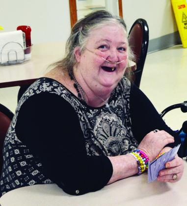 Virginia Caler explains the rules of the 52-card game they are playing called “Trailer Park” at River Valley Therapy Center. CDN | Christian Jacobsen