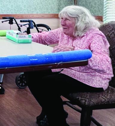 Teresa Griffin protects her goal during a game of air hockey at River Valley Therapy Center.