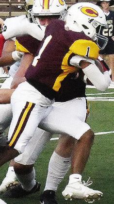 Clinton’s Derren Hester busts through the line of scrimmage with the ball for a gain during the Red Tornadoes’ game against Heritage Hall Friday. CDN | John Kinsey
