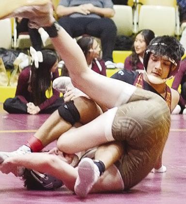 Carrol Hoffman gets Elk City’s Ethan Nelson to flip on his back as he goes to pin him Thursday during the Class 4A District 3 Wrestling Tournament in the Tornado Dome. CDN | Sam Goodwyn
