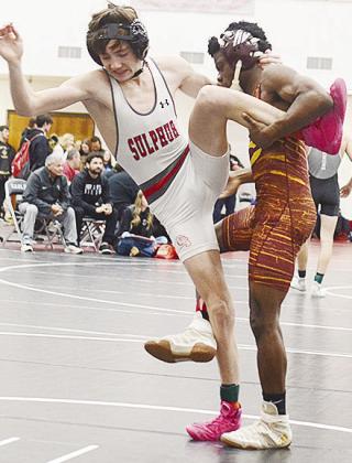 Clinton’s Marquis Martin, right, performs a single-leg takedown of his opponent during the Class 4A Regional Wrestling Tournament in Weatherford Friday. CDN | Sam Goodwyn